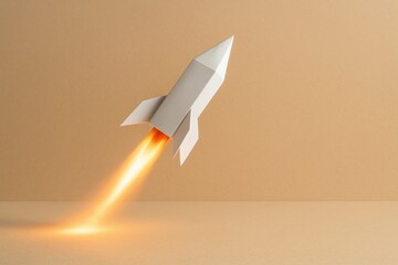 White rocket launching with flames on beige background used in startup success visuals business launch and innovation concepts