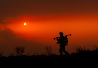 silhouette of a man with a rifle