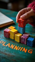 Fototapeta premium Building Strategy: Hand Stacking Colorful Blocks for Planning and Growth planning growth hand blocks