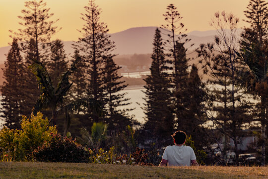 Man enjoying the sunset view over the water at Port Macquarie