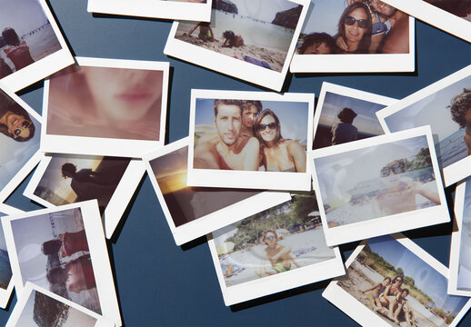 Mockup of Several polaroids are scattered randomly on a dark navy blue surface