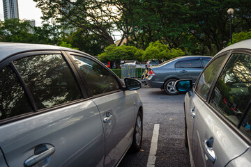 Outdooor car parking lot in city public park with tree