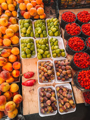 Fresh fruits in crates at open-air produce market