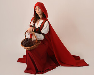 portrait pretty young female brunette model wearing a red hooded fairytale cloak and medieval...