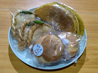 Various typical Indonesian market snacks, on white plates, displaying detailed textures and colors of traditional snacks.
