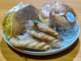 Various typical Indonesian market snacks, on white plates, displaying detailed textures and colors of traditional snacks.