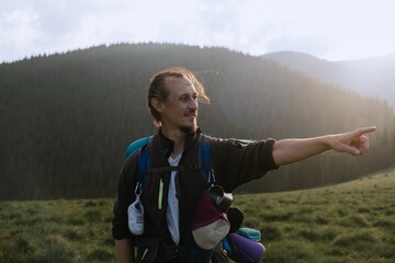 Hiker Pointing Toward Mountain View in Carpathian Mountains