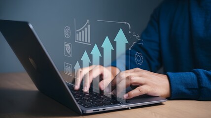 Person typing on laptop with digital growth chart and icons overlayed on the screen display view