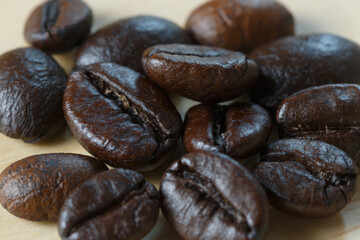 Dark roasted coffee beans  ,close up with coffee beans background