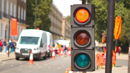 Traffic light in London street with visible construction site in the background