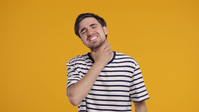 Young Man Has Sore. Sick Guy With Swollen Throat On Yellow Studio. Angina, pain
