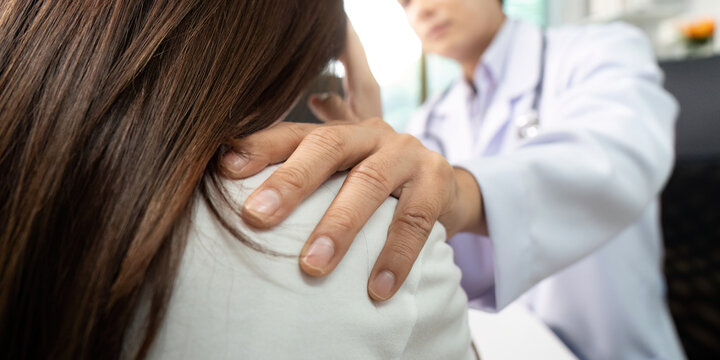 Healthcare. Doctor comforting patient with supportive touch on shoulder. - Powered by Adobe