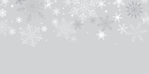 Christmas illustration featuring intricate falling snowflakes of varying sizes and designs arranged on top, white on gray background.
