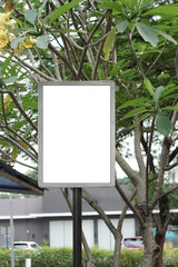 Blank vertical white sign with a grey frame in a garden for mockup. An empty outdoor billboard...