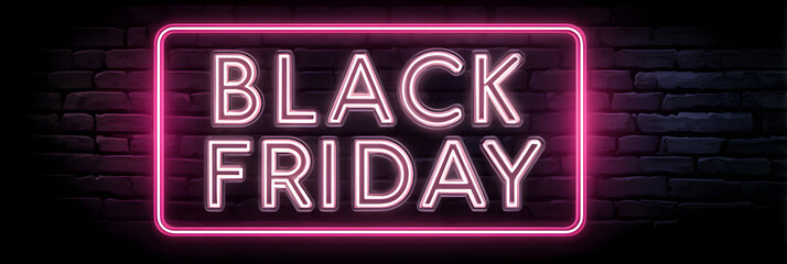 Promotion for upcoming shopping event features bright neon sign displaying Black Friday deals in an urban setting at night