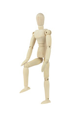 wooden man, wooden mannequin raised leg putting hand on knee isolated from background