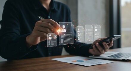 Person examining candidate profiles on a holographic interface with smartphone and pen in office