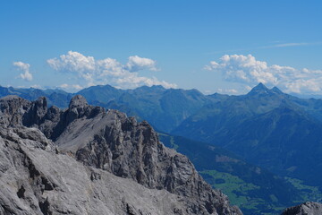 Fototapeta premium Panoramic View of Majestic Alpine Mountains and Valleys Under Blue Sky 