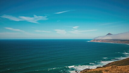 Fototapeta premium Coastal landscape with expansive ocean and clear blue atmosphere