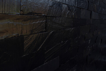 Horizontal vector illustration of dark black brick pattern background. Rough textured rustic background with space for text. No text and no people.