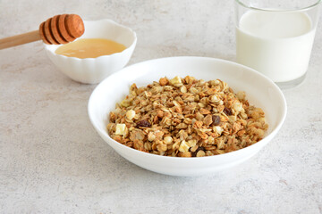 Granola in white bowl with Honey and Milk healthy breakfast 