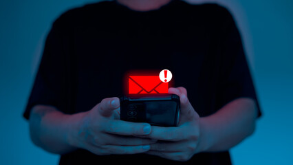 Close-up of hands holding smartphone with red email alert icon, representing phishing scam, cyber risk, and digital security warning on mobile device.