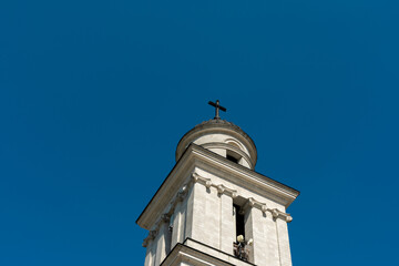 Historic church bell tower with cross, located in central Chisinau, Moldova, under clear blue sky...