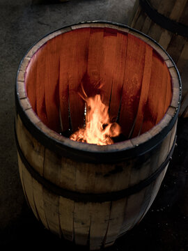 A whisky barrel being charred for storage