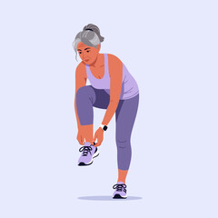 Mature Woman Tying Shoelaces Before Exercising Wearing Athletic Apparel
