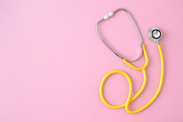 Fototapeta premium Medical Stethoscope on Pink Surface Representing Healthcare, Diagnosis, and Clinical Equipment for Health Professionals