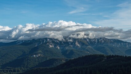 Cloud formations float atop the mountain.