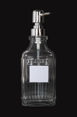 glass dispenser for a liquid hand soap isolated on black background