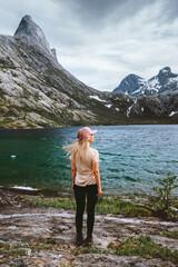 Woman traveling in Norway hiking solo active adventure journey, female tourist standing alone in...