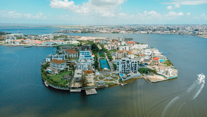 Aerial view of an exclusive island community with modern homes surrounded by the shimmering waters of Lagos Lagoon, a tranquil oasis, Lagos, Lagos, Nigeria.