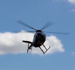 Helicopter soaring in the blue sky.