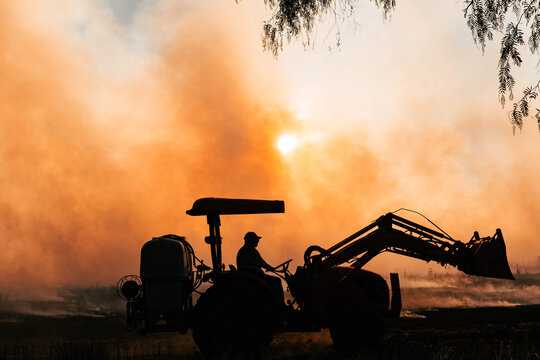 Small tractor in farm burn off
