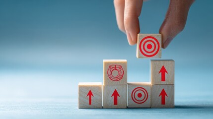 The hand placing a block on a stacked target-driven strategy tower.