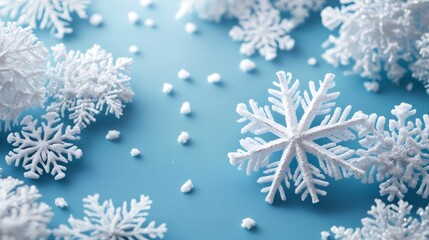 White snowflakes decoration lying on light blue background