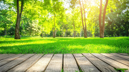 Fototapeta premium A wooden deck with a view of a lush green park with trees and sunlight filtering through the leaves.