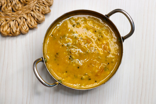Traditional Indian yellow dal tadka made with toor dal, tempered with ghee, garlic, cumin, and red chilies. Served hot with rice or roti. Comfort food with rich flavor and vibrant color.