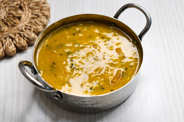 Traditional Indian yellow dal tadka made with toor dal, tempered with ghee, garlic, cumin, and red chilies. Served hot with rice or roti. Comfort food with rich flavor and vibrant color.