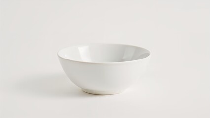 Empty round white ceramic bowl positioned on a plain white surface showcasing minimalistic design and smooth texture