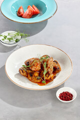 Pork medallions in sweet chili sauce with grilled potatoes and mushrooms, bright flatlay