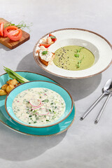 Okroshka and spinach cream soup with shrimp, bright natural lighting, overhead composition