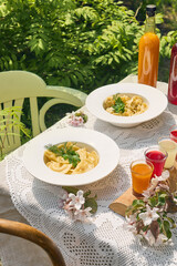 Pelmeni and vareniki set, bright rustic lighting, overhead summer table composition