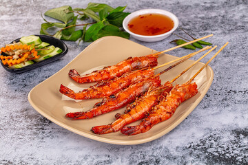 Grilled prawn skewer served sauce