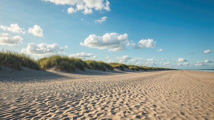 A vast view of sandy hills and an almost empty shoreline in spring