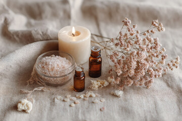 Relaxation Day theme.Spa flat lay with candles,dry flowers,bath salt, essential oils on natural linen background.Body care moment for females.Minimalist setup with serenity, simplicity, and vitality.