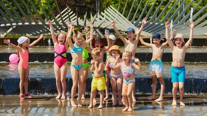 Children playing joyfully in a splash pad during a sunny summer day. Concept of modern swimwear banner, boutique fashion content for kids, seasonal outfit inspiration for catalogs © Lustre Art Group 