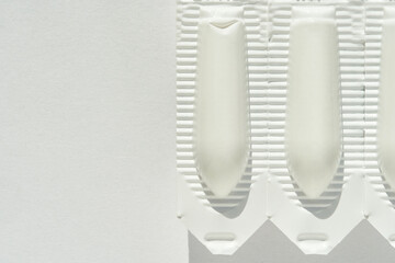 Rectal suppositories in blister pack on white background for medical use.
